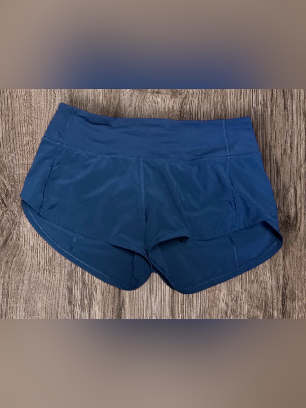 Lululemon Speed Up Shorts in a navy blue color featuring a zippered back pocket